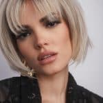 Blonde bob wig with layered cut and side-swept bangs from Hidden Secrets Wigs.